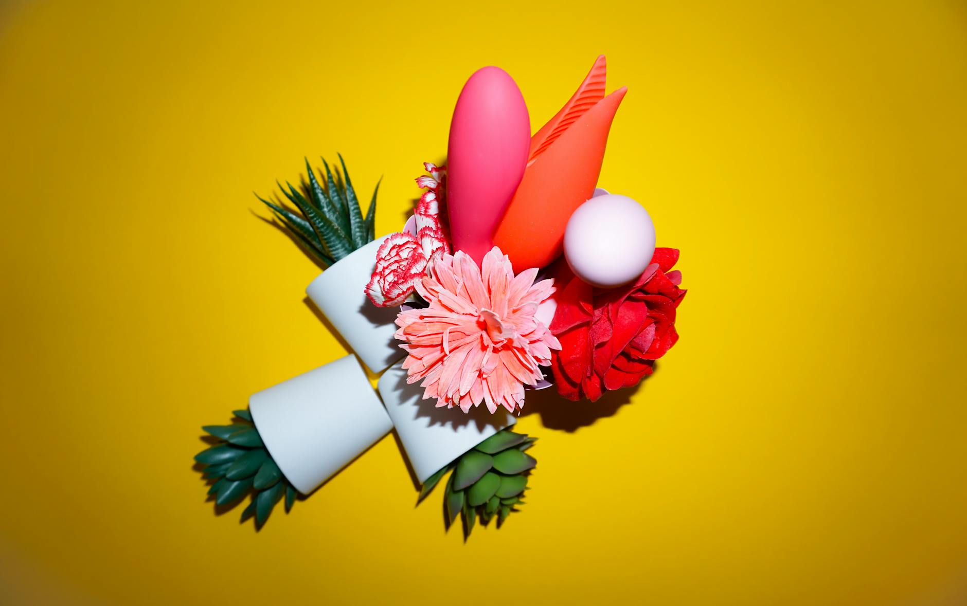 Colorful arrangement of toys and objects on a bright yellow background